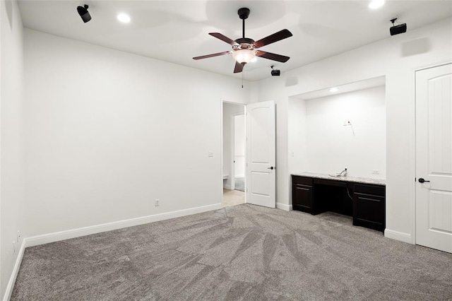 unfurnished bedroom with recessed lighting, light colored carpet, a ceiling fan, and baseboards