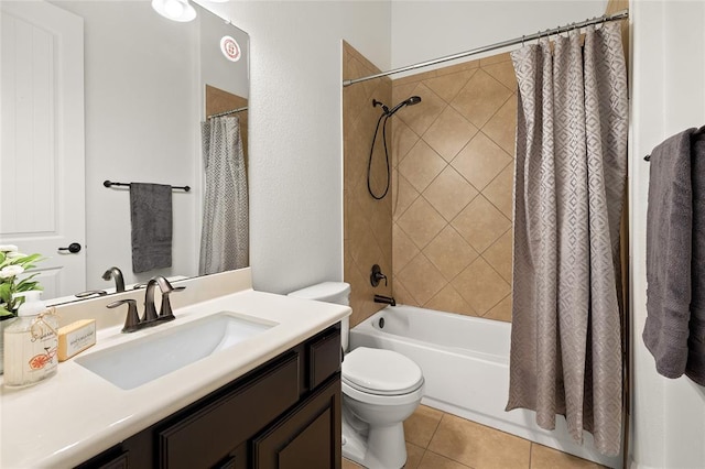 full bath with tile patterned floors, shower / bath combo with shower curtain, toilet, and vanity