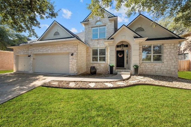 view of front of home featuring fence, a front yard, a garage, stone siding, and driveway