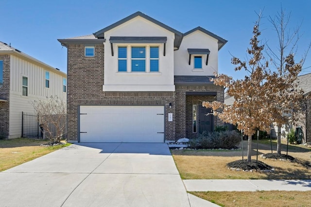 view of front of home with a garage, brick siding, driveway, and stucco siding