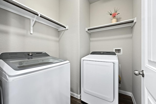 laundry area with wood finish floors, baseboards, independent washer and dryer, and laundry area