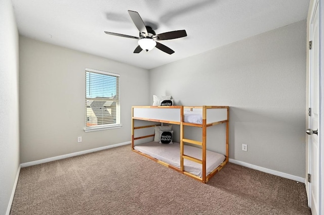 carpeted bedroom with baseboards and ceiling fan