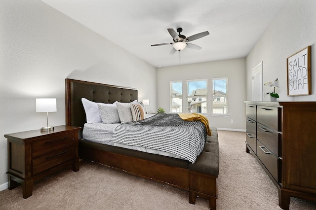 bedroom with baseboards, light colored carpet, and ceiling fan