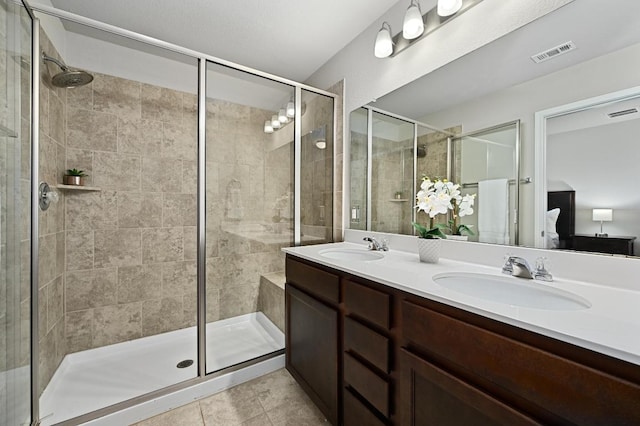 full bath featuring a stall shower, visible vents, and a sink