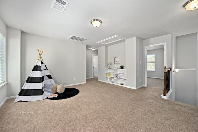 playroom featuring attic access, baseboards, visible vents, and carpet floors