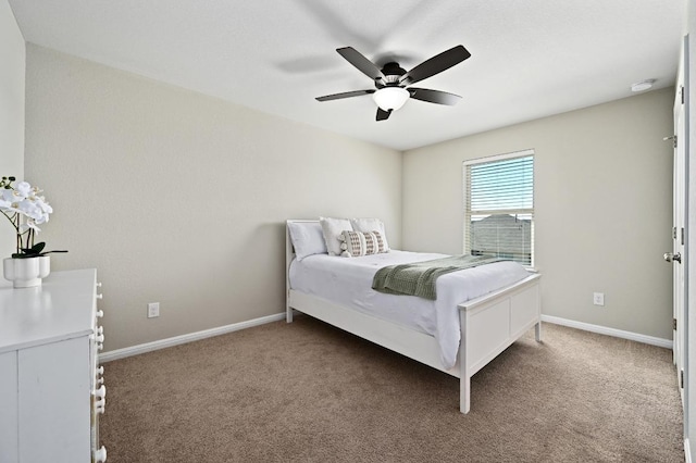 bedroom featuring baseboards, a ceiling fan, and carpet flooring