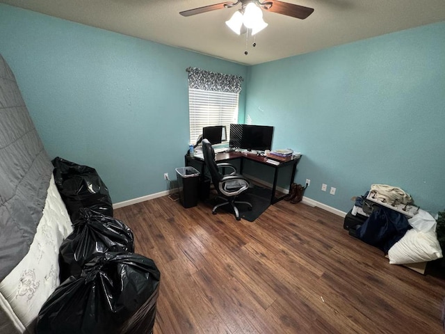 office space with baseboards, wood finished floors, and a ceiling fan