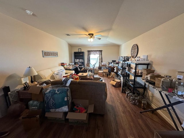 living area with ceiling fan, visible vents, wood finished floors, and vaulted ceiling