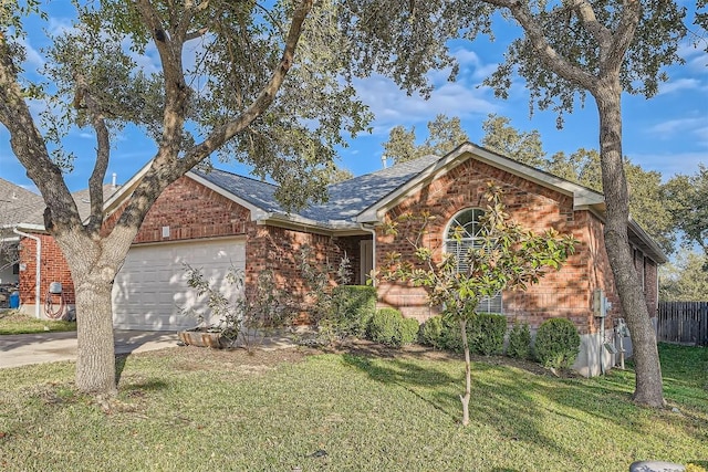 single story home with a front lawn, an attached garage, brick siding, and driveway