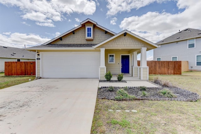 craftsman inspired home featuring a front yard, an attached garage, driveway, and fence