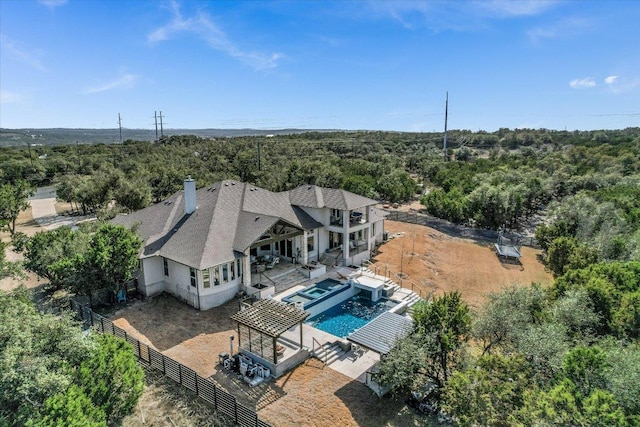 bird's eye view featuring a wooded view