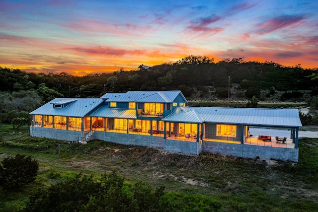 back of property at dusk with metal roof