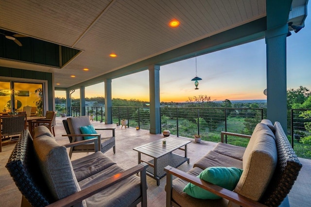 patio terrace at dusk featuring an outdoor hangout area