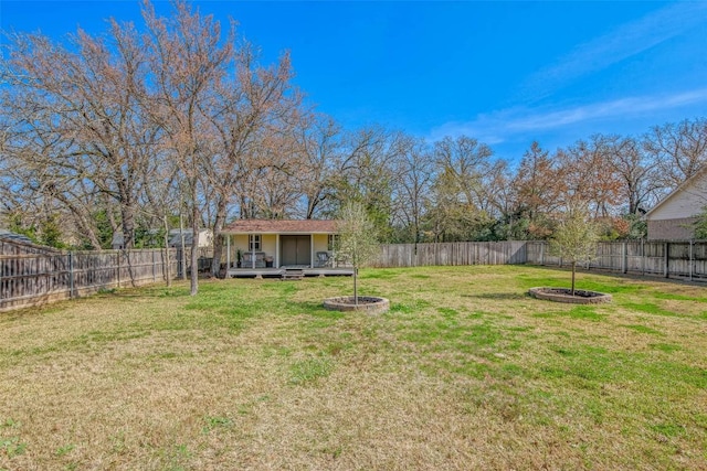 view of yard featuring a fire pit, an outbuilding, and a fenced backyard