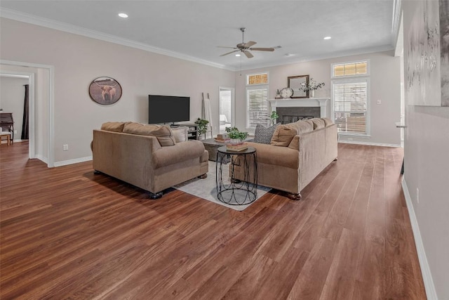 living area featuring wood finished floors and ornamental molding