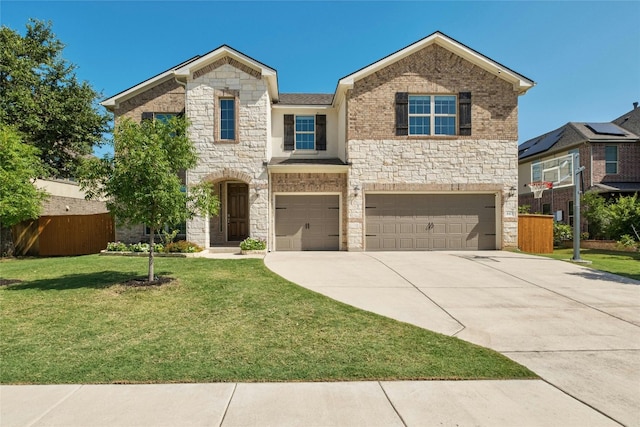 view of front of home featuring a front yard, fence, driveway, stone siding, and a garage