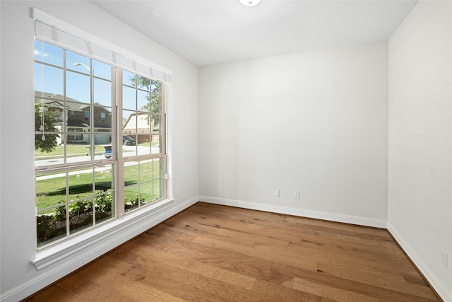 unfurnished room featuring wood finished floors and baseboards