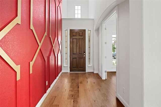 entrance foyer featuring baseboards and hardwood / wood-style floors