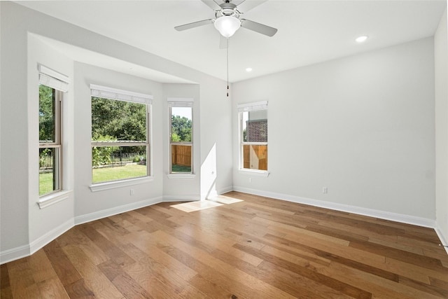 empty room with recessed lighting, baseboards, and light wood finished floors