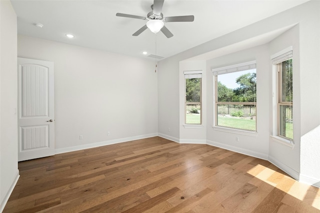 unfurnished room with recessed lighting, a ceiling fan, baseboards, and hardwood / wood-style flooring