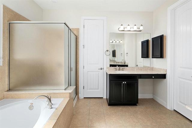 full bath featuring tile patterned floors, vanity, a garden tub, and a shower stall