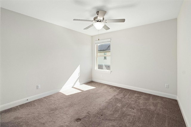 empty room featuring carpet flooring and baseboards