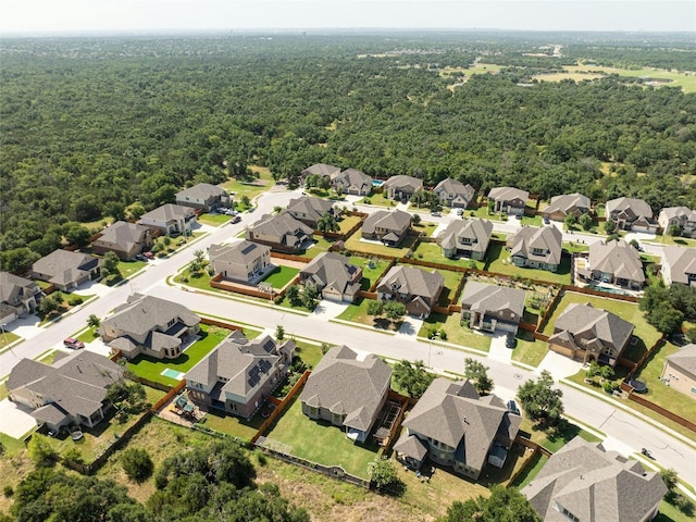 bird's eye view featuring a forest view and a residential view