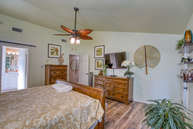 bedroom featuring lofted ceiling, wood finished floors, and visible vents