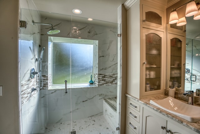 full bathroom with recessed lighting, a marble finish shower, and vanity