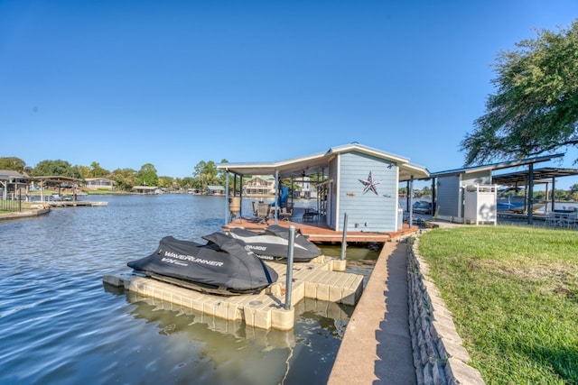 dock area with a water view and boat lift