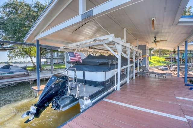 view of dock featuring boat lift and a water view