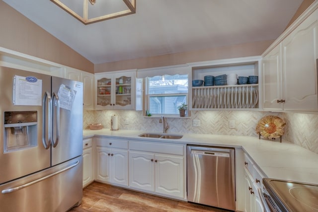 kitchen featuring a sink, appliances with stainless steel finishes, and white cabinets