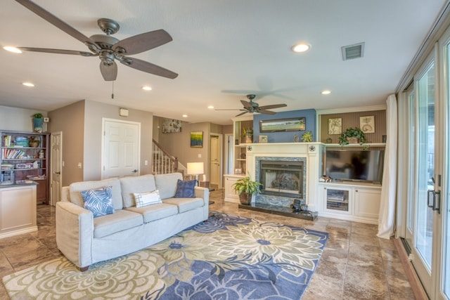 living area featuring visible vents, recessed lighting, built in shelves, and stairs