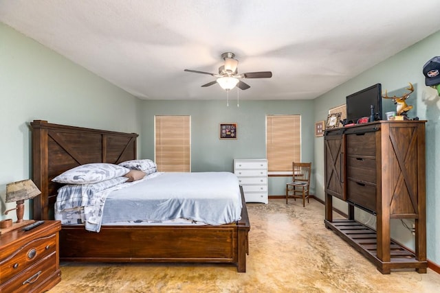 bedroom with a ceiling fan and baseboards