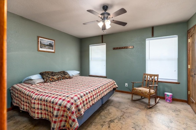 bedroom featuring a ceiling fan and baseboards