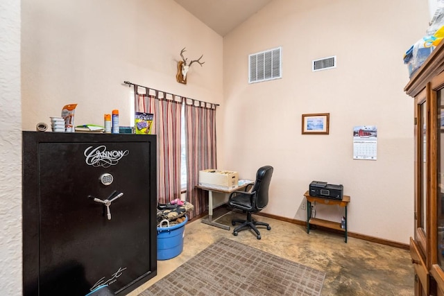 home office with visible vents, baseboards, and high vaulted ceiling