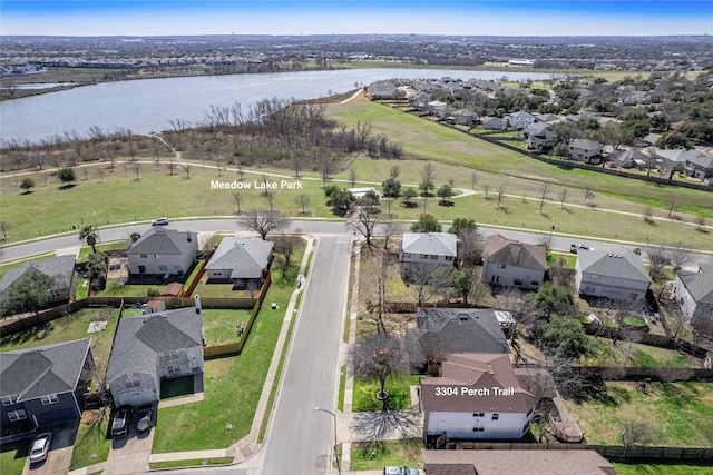 drone / aerial view featuring a residential view and a water view