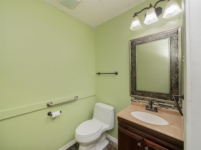 bathroom with toilet, backsplash, a textured ceiling, baseboards, and vanity