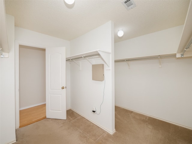 spacious closet with visible vents and light carpet