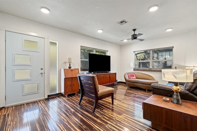 living area with visible vents, dark wood-type flooring, baseboards, ceiling fan, and recessed lighting