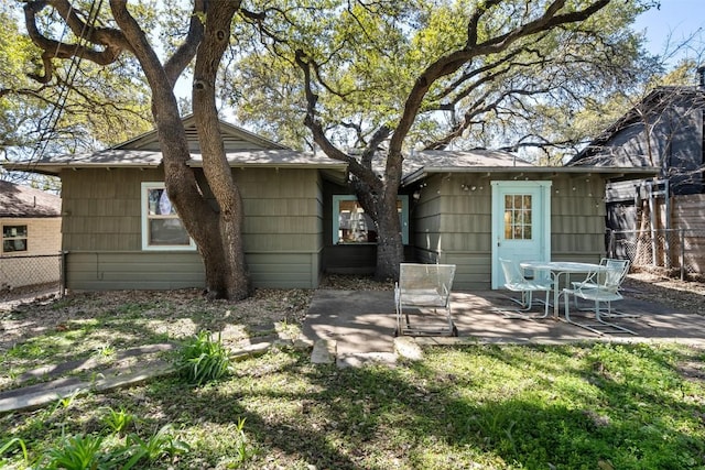 rear view of house with a patio and fence