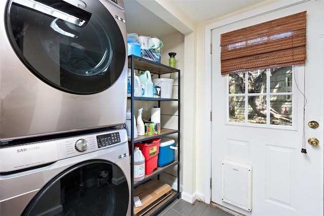 laundry room with stacked washer and dryer and laundry area