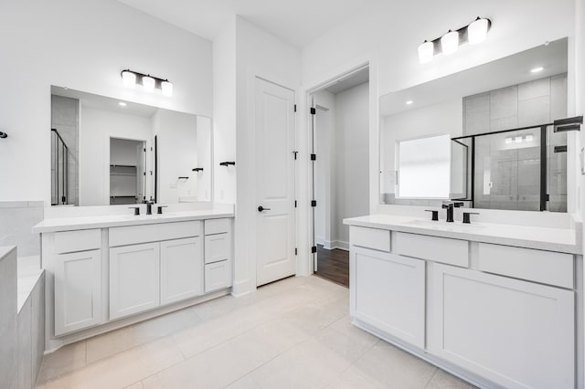 1821 Novara Trl, Leander, TX 78641 - bathroom with a stall shower, two vanities, tile patterned floors, and recessed lighting