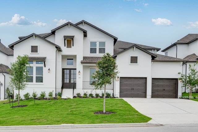 1821 Novara Trl, Leander, TX 78641 - view of front of home with stucco siding, french doors, driveway, a front lawn, and a shingled roof