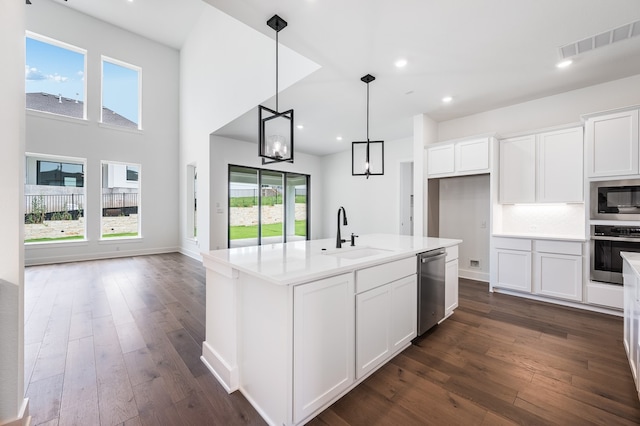 1821 Novara Trl, Leander, TX 78641 - kitchen featuring a sink, stainless steel appliances, white cabinets, dark wood finished floors, and recessed lighting