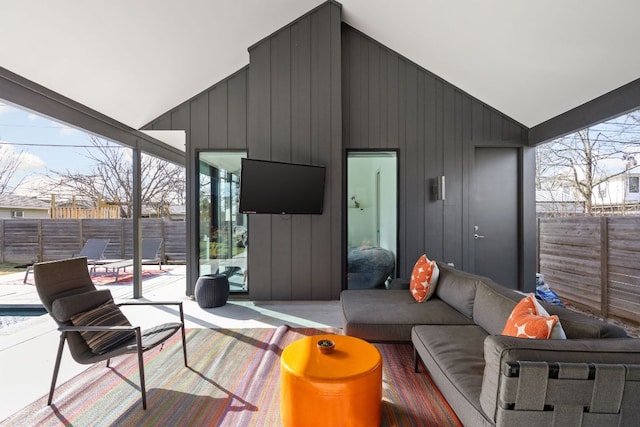 wooden deck with an outdoor living space, a fenced backyard, and a patio area