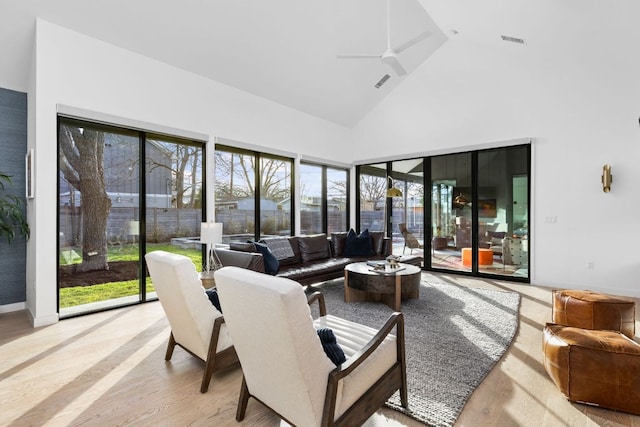 sunroom / solarium with visible vents, ceiling fan, and lofted ceiling