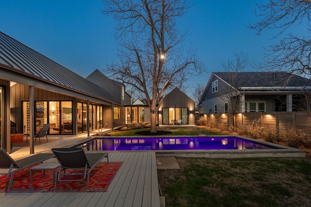 view of swimming pool with a fenced in pool, a deck, and fence