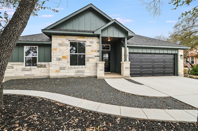 view of front facade with concrete driveway, a garage, board and batten siding, and roof with shingles