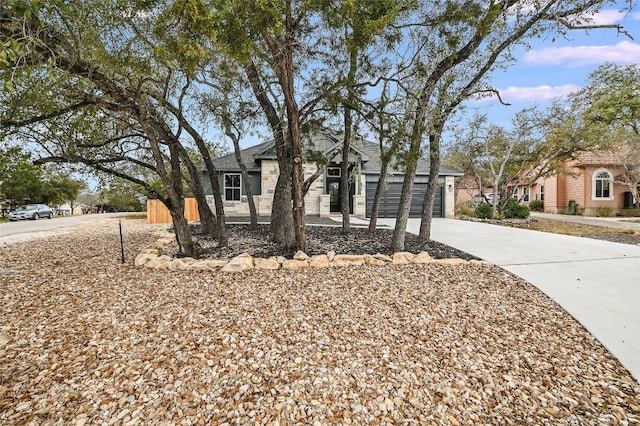 view of front of home featuring concrete driveway and an attached garage